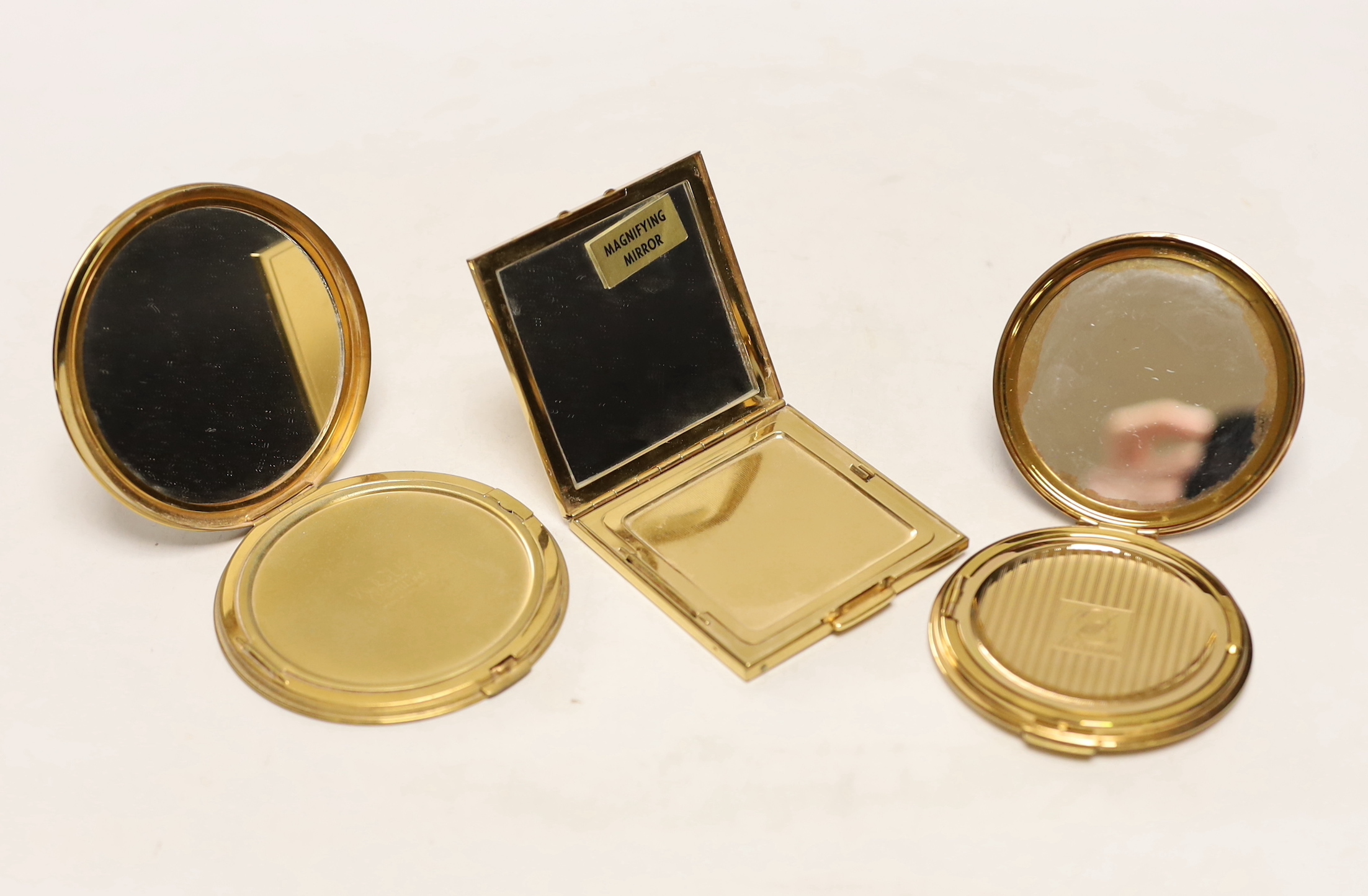 Three compact mirrors, collection consisting of an example of one each of a Stratton Flying Ducks, King K&K Sunburst and Vanities Dragon design.